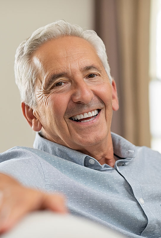 Man sharing smile after tooth replacement with dentures