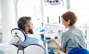 dentist showing an X-ray to the patient