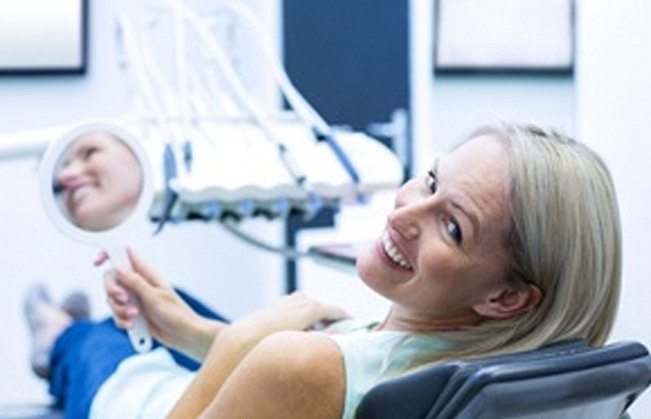 Woman in dental chair smiling