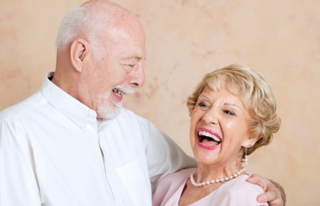 Man and woman enjoying the benefits of all on four dental implants