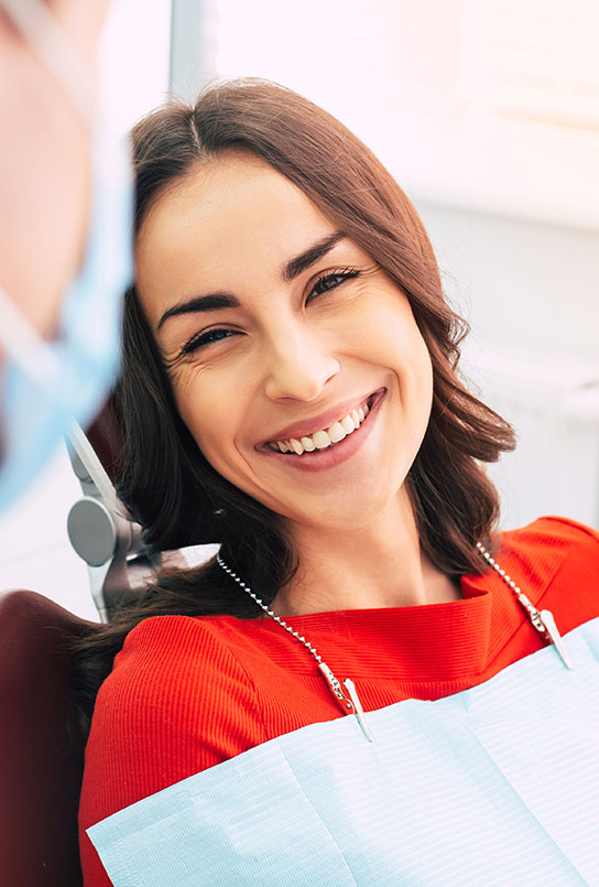 Woman smiling during dental checkup and teeth cleaning visit