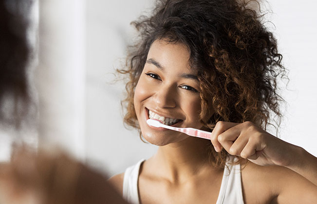 Woman brushing teeth