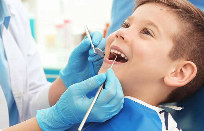 Dentist examining child's smile