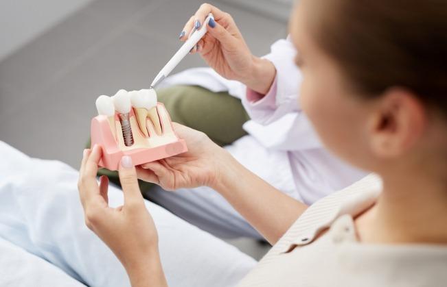 Dentist and patient discussing the dental implant process