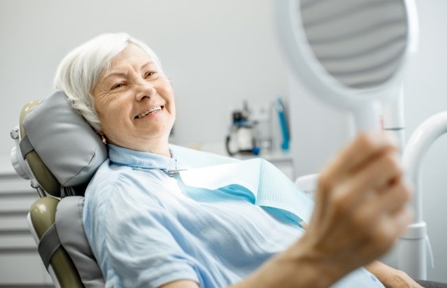 Smiling woman enjoying the benefits of dental implants