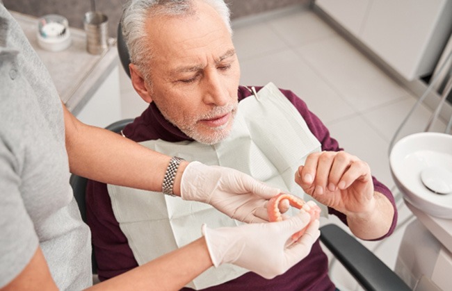 Man getting dentures at the dentist