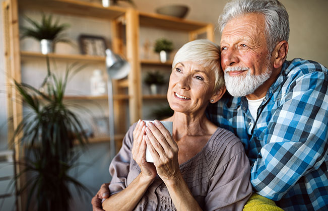 Man and woman with dentures smiling together