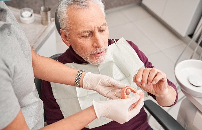 Man getting dentures at the dentist