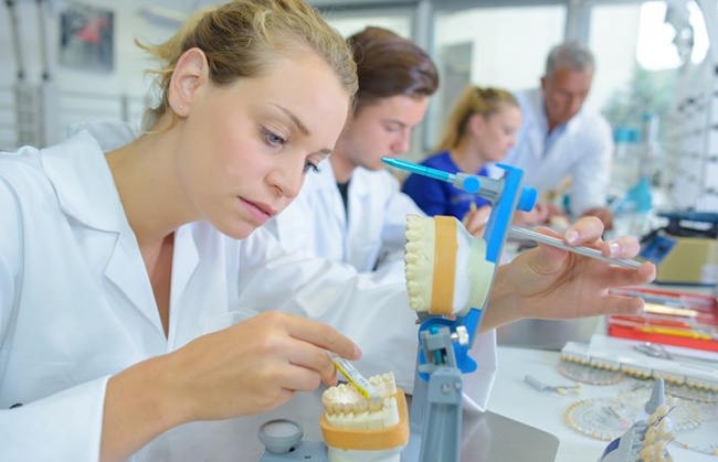 Dental lab technician working on dentures