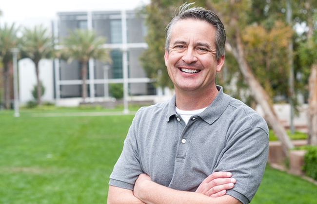 man smiling while standing outside