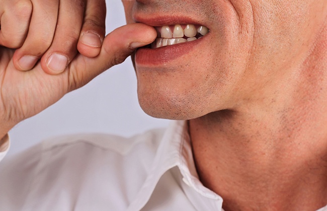 man biting fingernails 