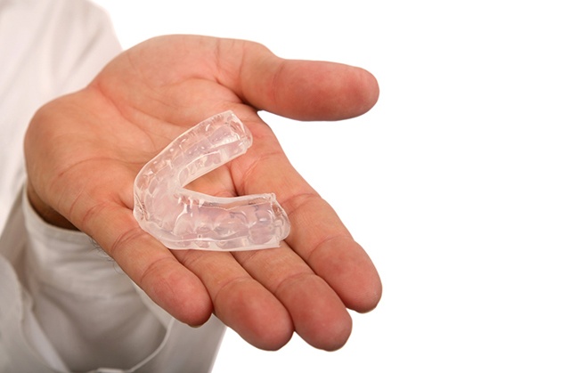 man holding mouthguard