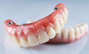 Implant dentures resting against neutral background
