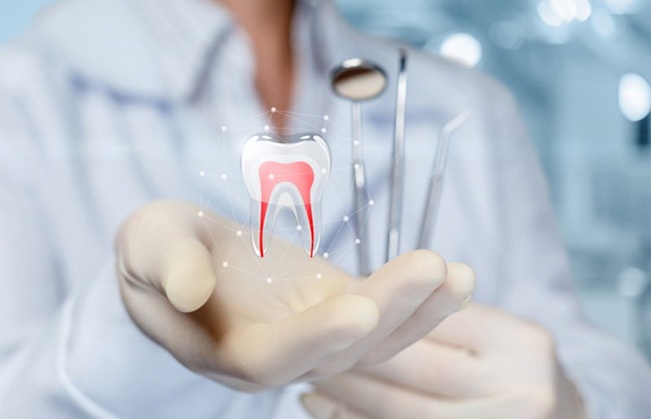 a dentist holding a digital tooth for dental implant technology