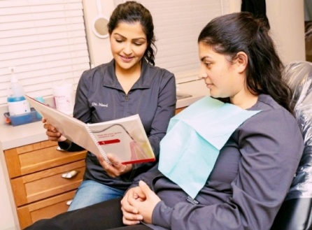 Dentist talking to dental patient