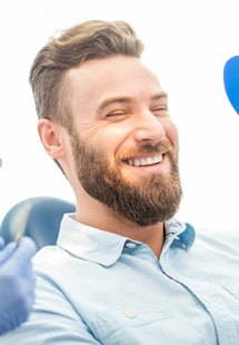 : man smiling in dental mirror 