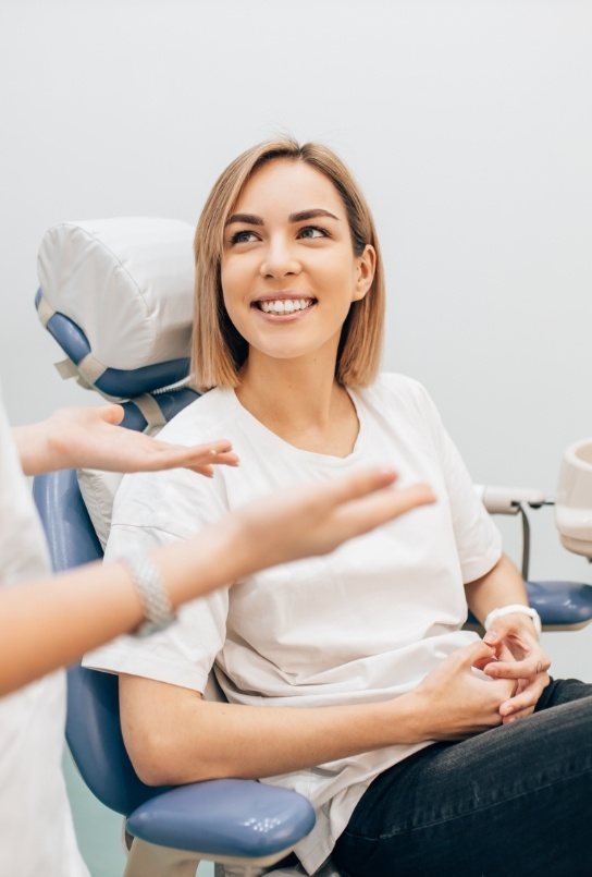 Woman smiling at dentist after root canal treatment