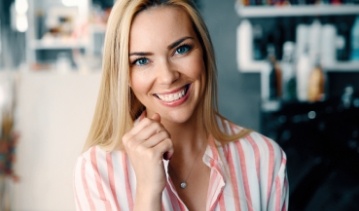 Woman with perfectly aligned smile after Invisalign treatment