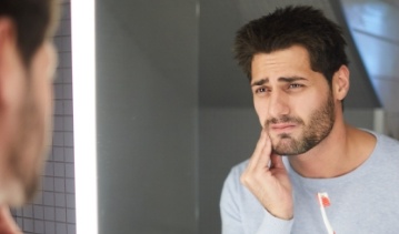 Man in pain before gum disease treatment