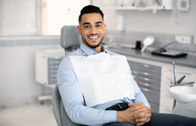 Patient smiling while sitting in treatment chair