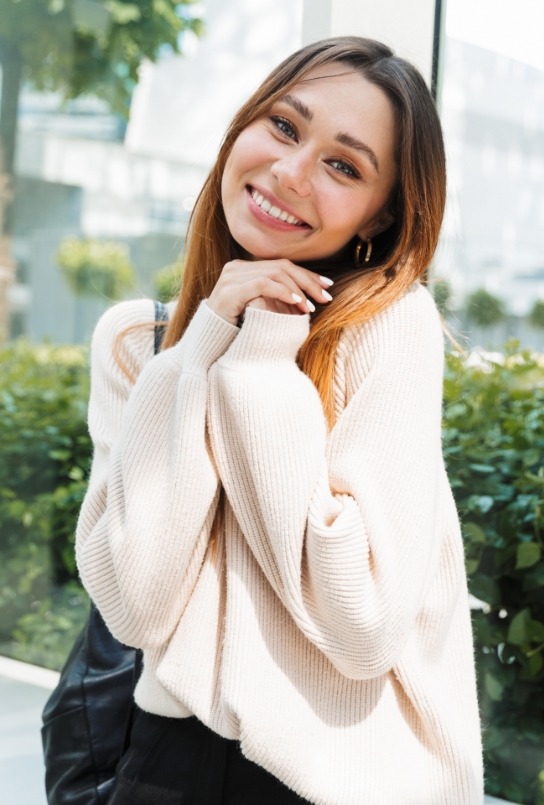 Woman sharing healthy smile after tooth extractions