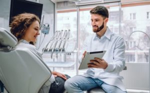 dentist explaining dental implant cost to a patient 