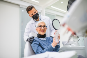 a closeup of a patient inspecting their dental implants